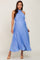 woman wearing a light blue pleated maternity dress with a halter neck and a tie waist, showcasing her baby bump