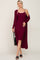 Woman wearing a burgundy ribbed midi dress with a matching long cardigan and black sandals