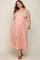 Pregnant woman wearing a pink floral smocked maternity midi dress with spaghetti straps