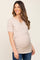 smiling pregnant woman wearing a beige ribbed short sleeve maternity and nursing top with blue jeans