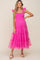woman wearing a bright pink maternity dress with ruffled sleeves and tiered tulle skirt