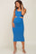 pregnant woman wearing a blue ribbed midi maternity dress with side cutouts and tan heels