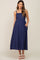 woman wearing a navy blue sleeveless maternity midi dress with pockets and square neckline