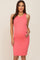 pregnant woman wearing a coral pink ribbed maternity midi dress with a gold necklace