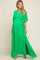 Pregnant woman wearing a green v-neck maternity maxi dress with short sleeves and a side slit