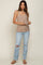 woman wearing a beige ribbed maternity tank top and distressed light blue jeans, holding sunglasses