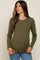 woman wearing an olive green long sleeve maternity top and showcasing her baby bump