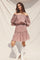 woman wearing a pink floral off-the-shoulder dress with puff sleeves and a ruffled hem, paired with white cowboy boots