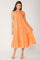 woman wearing an orange tiered midi dress with a v-neck and ruffled hem