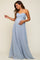 woman wearing a light blue strapless maternity dress with a fitted bodice, flowing skirt, and holding her baby bump