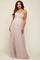 woman wearing a blush strapless maternity maxi dress with ruched bodice and flowing skirt, showcasing her baby bump