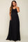 woman wearing a black strapless maternity gown with gathered detailing and a visible baby bump