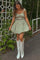 woman wearing a floral print mini dress with tie straps and white cowboy boots