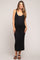 woman wearing a black ribbed maternity maxi dress with a deep v-neck and side slits, showcasing her baby bump