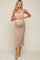 woman wearing a light brown ribbed maternity dress, showcasing her baby bump while posing with one hand on her belly