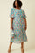 woman wearing a floral plus-size midi dress with short sleeves and a gathered waist, holding a small white bag