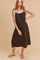 woman wearing a black midi dress with adjustable straps and a relaxed fit