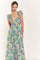 woman wearing a floral maxi dress with ruffled sleeves and a deep v-neckline