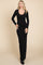 woman wearing a black long sleeve fitted maxi dress with a scoop neckline