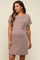 woman wearing a light brown short sleeve maternity dress with a pocket and a visible baby bump