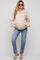 woman wearing a beige maternity hoodie with a collar and pockets, paired with light blue jeans and sunglasses