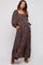 woman wearing a black floral maternity maxi dress with a square neckline and puff sleeves, featuring pockets