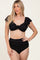 woman wearing a black ribbed bikini with ruffle sleeves and high-waisted bottom