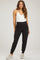 woman wearing a white maternity bodysuit and black maternity jogger pants with pockets and elastic cuffs