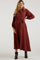 woman wearing a rust long sleeve button-up maternity dress with a tie waist and a visible baby bump