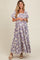 woman wearing a floral print maternity maxi dress with short sleeves and a square neckline