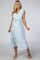 pregnant woman in light blue maternity midi dress with white floral embroidery and ruffle sleeves