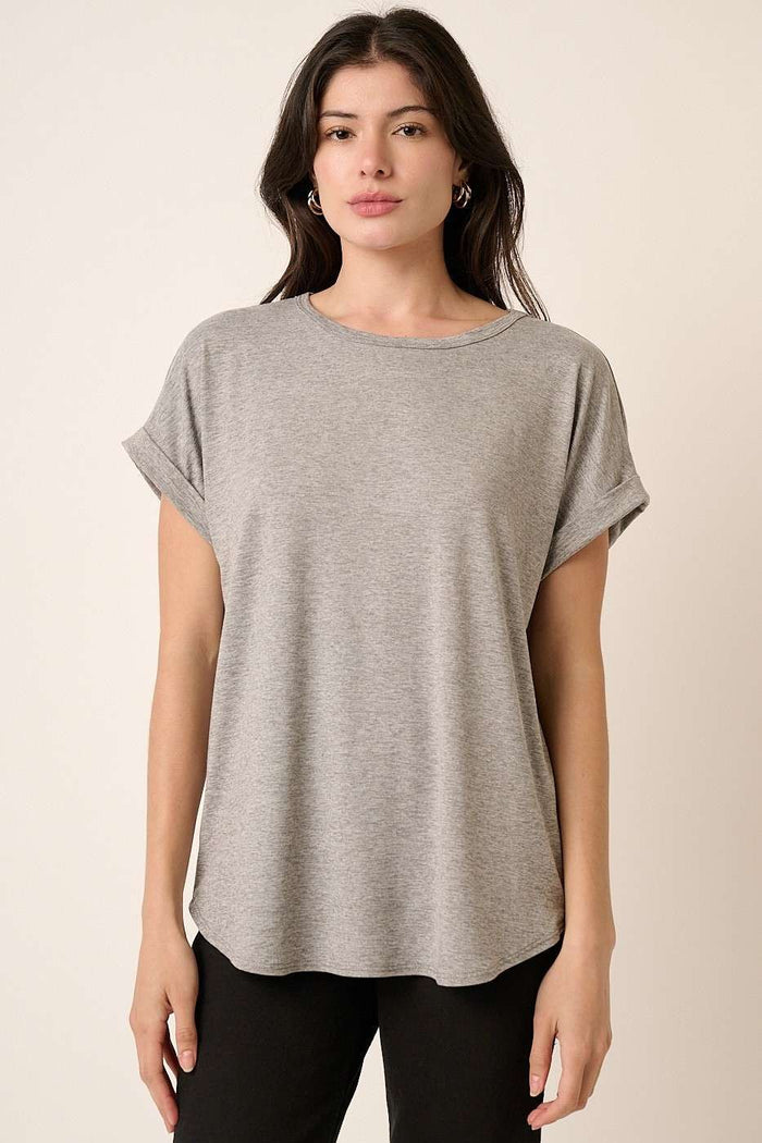 woman wearing a gray short sleeve t-shirt with rolled cuffs and a relaxed fit