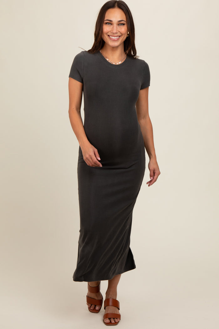 woman wearing a dark gray short sleeve maternity maxi dress and holding her baby bump