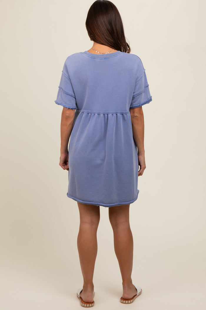 woman wearing a light blue short sleeve maternity dress with a relaxed fit and frayed hem