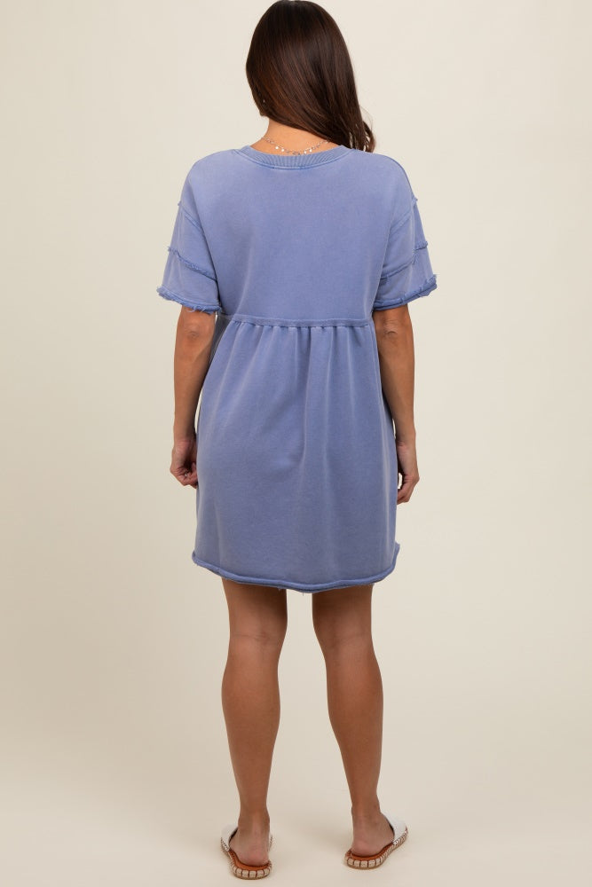 woman wearing a light blue short sleeve maternity dress with a relaxed fit and frayed hem