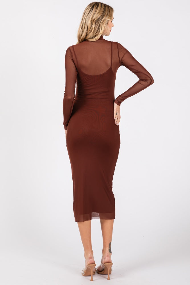 woman wearing a brown long sleeve fitted midi dress with a sheer overlay from the back