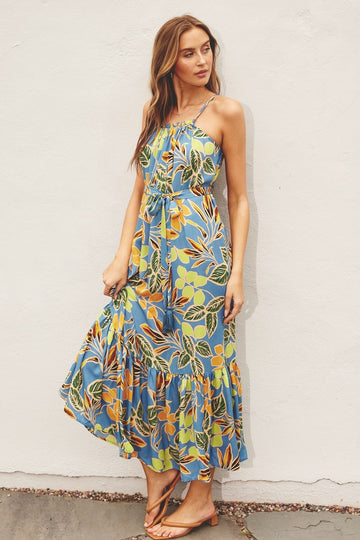 woman wearing a blue floral maxi dress with spaghetti straps and a tiered skirt