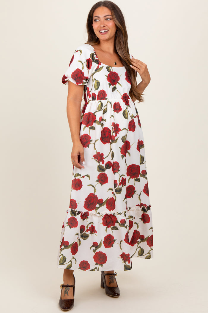 woman wearing a floral maternity maxi dress with puff sleeves and a square neckline, showing a baby bump