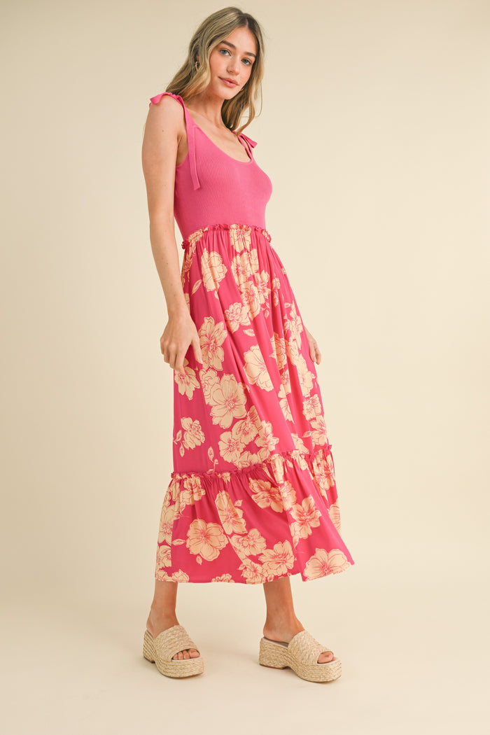 woman wearing a pink ribbed tank top and a long floral tiered maxi skirt with espadrille wedges