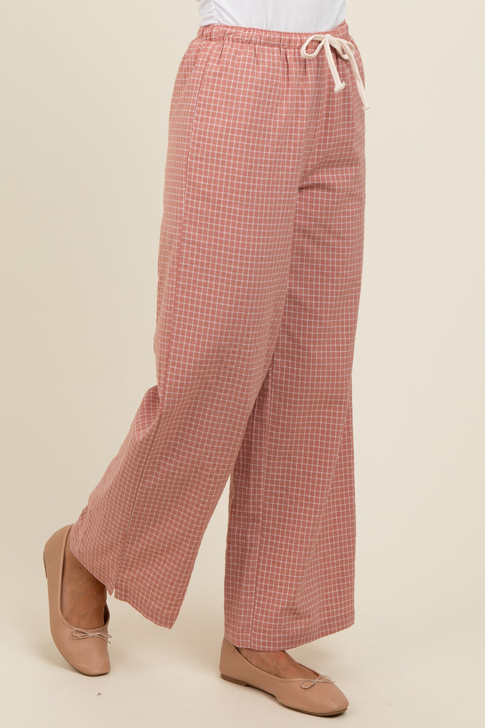 woman wearing pink checked wide-leg pants with an elastic waistband and drawstring