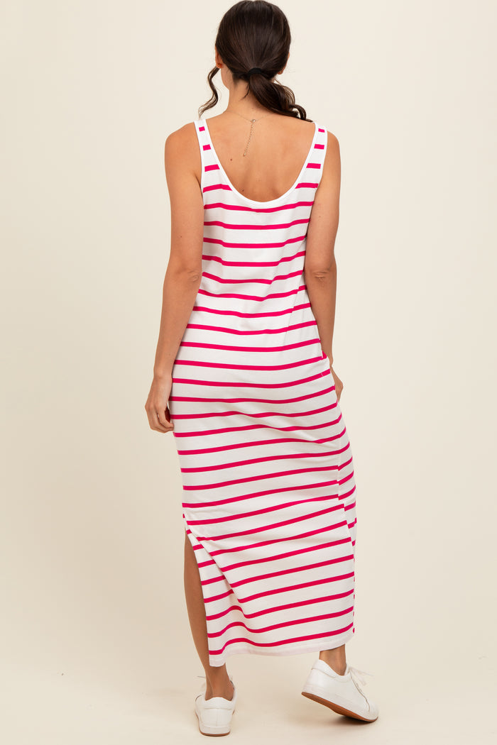 woman wearing a sleeveless pink and white striped maxi dress with a high slit and white sneakers