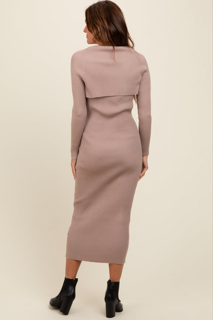 woman wearing a light pink ribbed knit midi dress with a foldover neckline and long sleeves, viewed from the back