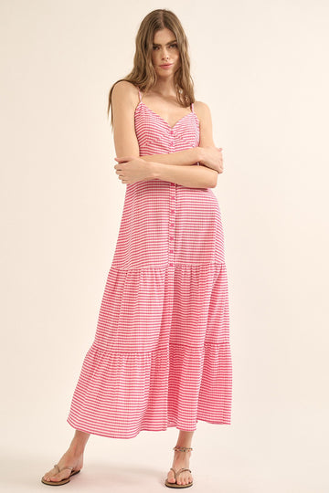 woman wearing a red and white striped maxi dress with button detailing and tiered skirt