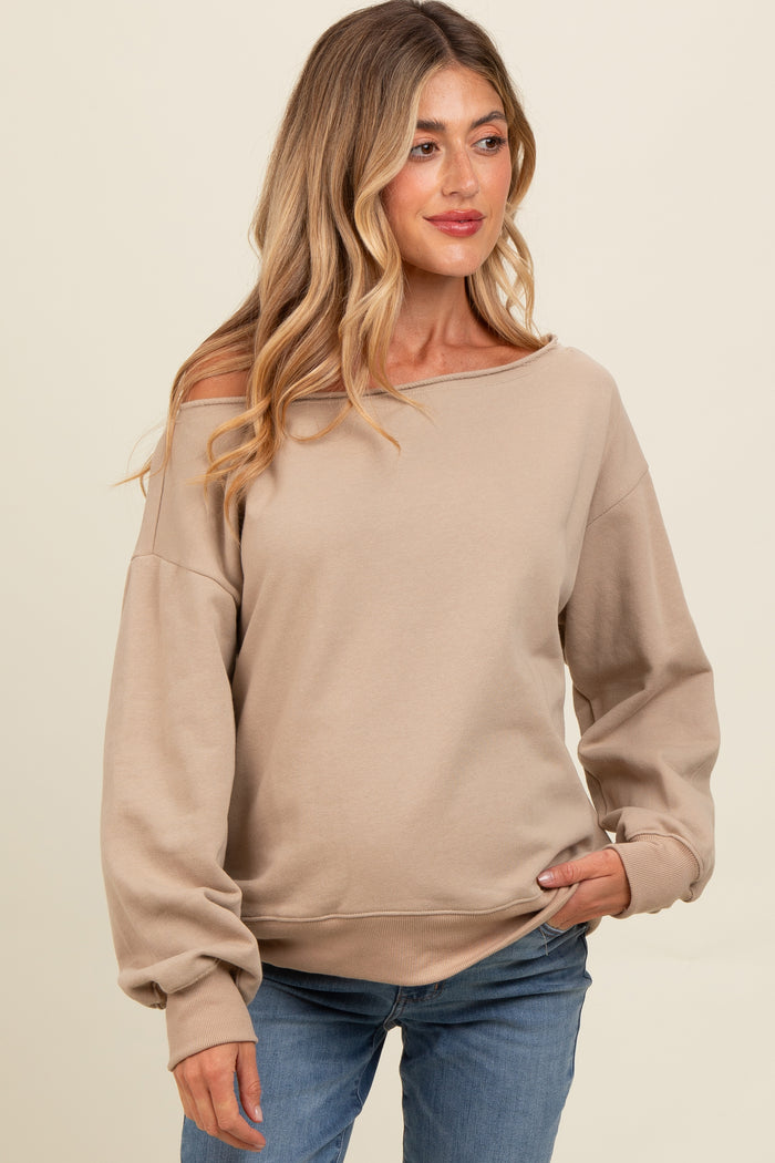woman wearing a beige off-shoulder maternity sweatshirt with balloon sleeves and relaxed fit