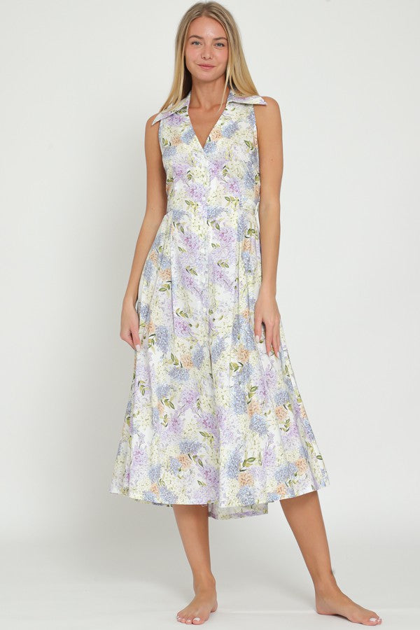 woman wearing a floral sleeveless midi dress with a v-neck and flared skirt