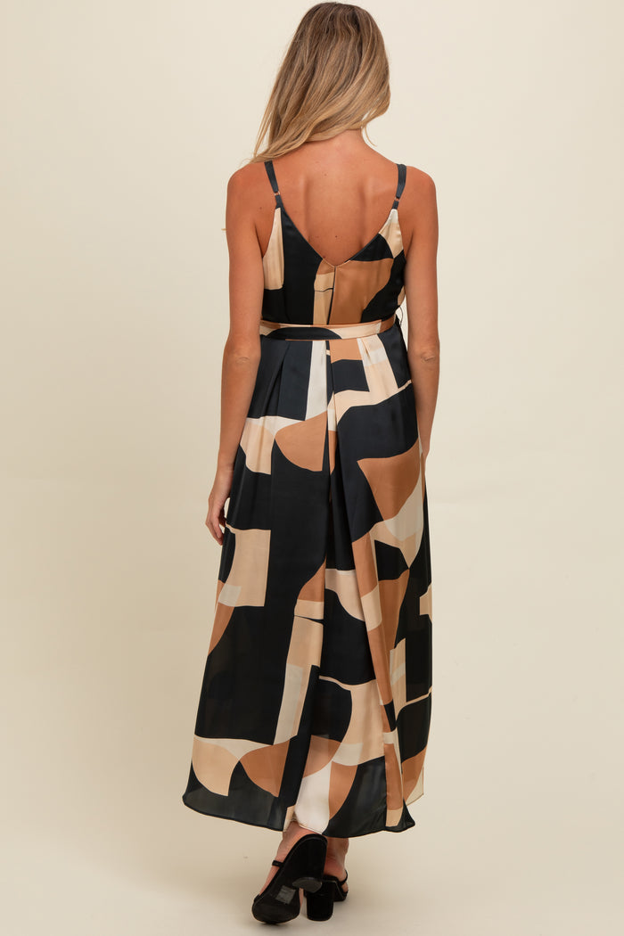 woman wearing a black and beige patterned maternity maxi dress with spaghetti straps, showing a comfortable fit