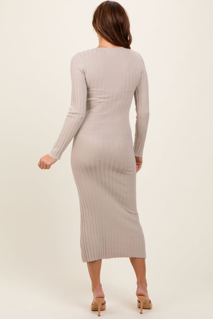 woman wearing a beige ribbed long sleeve midi dress, viewed from the back