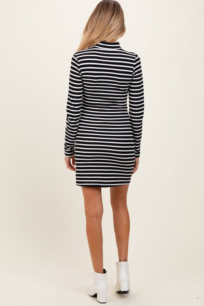 woman wearing a black and white striped long sleeve maternity dress, showing the back view
