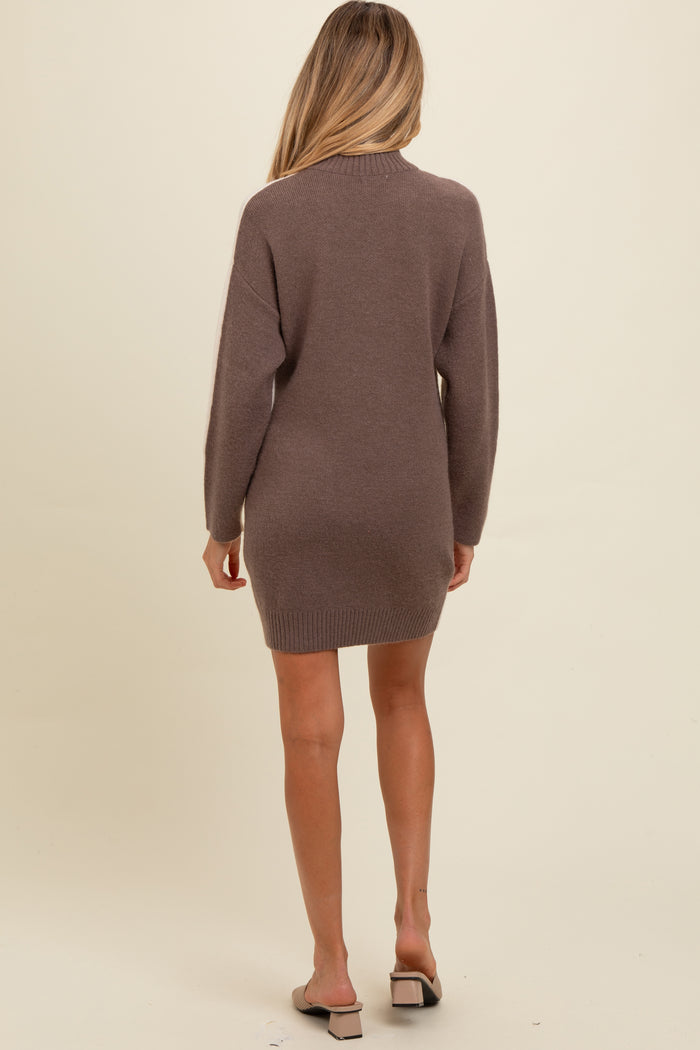 woman wearing a brown maternity sweater dress with long sleeves, shown from the back