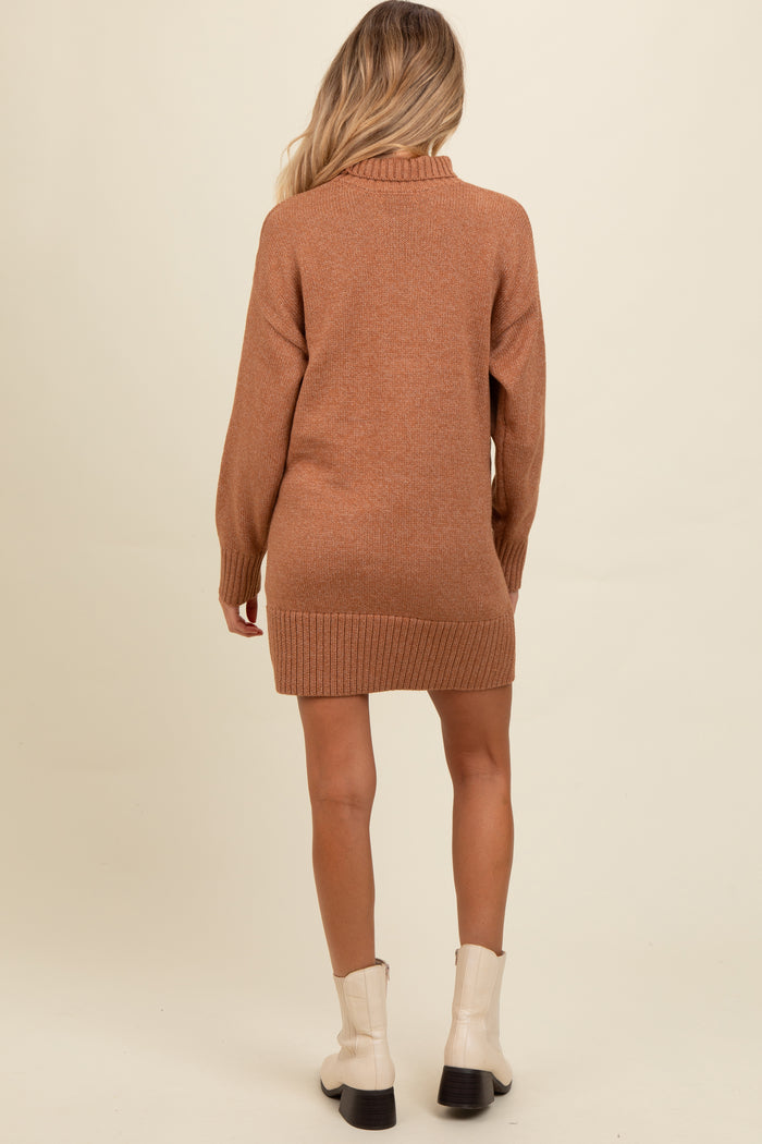 woman wearing a brown maternity sweater dress with a ribbed hem and a cowl neck, showing a subtle back view